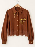 lace blouse with gold-tone pins